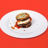 Eggplant Parmesan · Breaded eggplant topped with marinara sauce and melted mozzarella cheese. Served with your c...