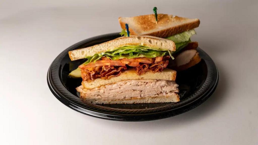 Turkey Club · Triple decker sandwich with bacon, lettuce and tomato.