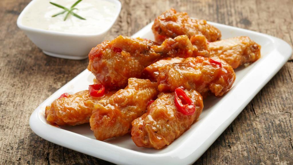 Thai Chili Wings · Golden, crispy wings glazed with sweet and spicy Thai Chili sauce.