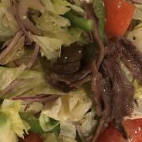 Greek Salad · Iceberg lettuce, feta, tomato, cucumber, black olives, red onion, stuffed grape leaves, anch...