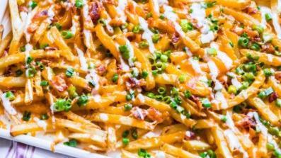 Bacon Loaded Fries · Our crispy French fries piled high, topped with bacon and shredded cheese. Served with ranch dipping sauce