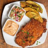Chicken Schnitzel Dish · Golden sesame - crusted chicken cutlet, israeli salad, garlic-parsley potatoes and harissa a...