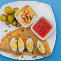 Malawach · Yemenite fried flatbread with hard boiled egg, grated tomato, pickles, and tahini sauce.