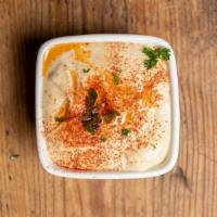 Hummus · Vegetarian, gluten-free. Freshly made and topped with tahini sesame seed sauce, masabacha (s...