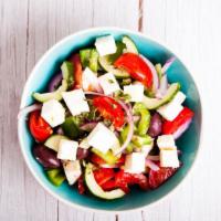 Classic Greek Salad · Our traditional Greek salad is made with fresh mixed greens, crisp cucumbers, tomatoes, impo...
