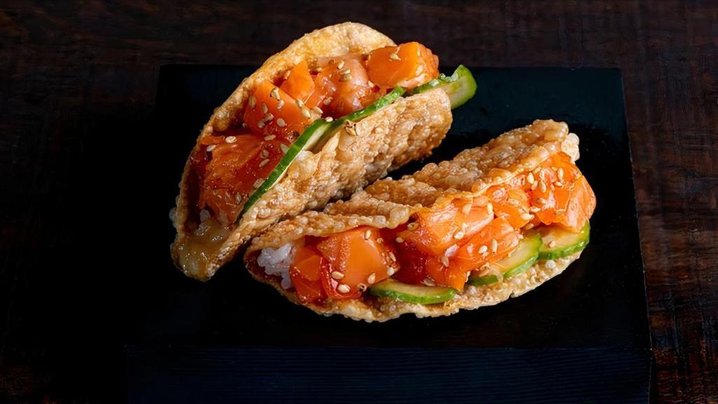 Salmon Taco · Salmon, Miso Vinegar, Cucumber, Sushi Rice and Sesame Seeds in a Gyoza Shell. Order comes with two tacos.