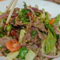 Grilled Beef Salad · Spicy. Lettuce, tomato, scallion, red onion, cucumber, mint tossed with spicy lime dressing.