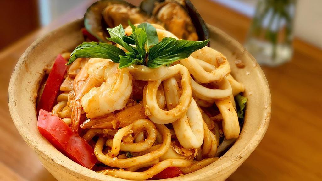 Seafood Basil Udon Noodle · Udon Noodle, shrimp, squid, mussels, bamboo shoot, basil, red bell pepper, carrot, garlic, and onion