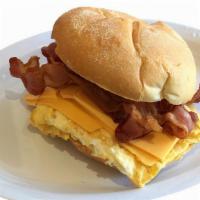 Huevos Jamon Y Queso (Bagel, Croissant Or Roll) · Eggs any style with ham and cheese.