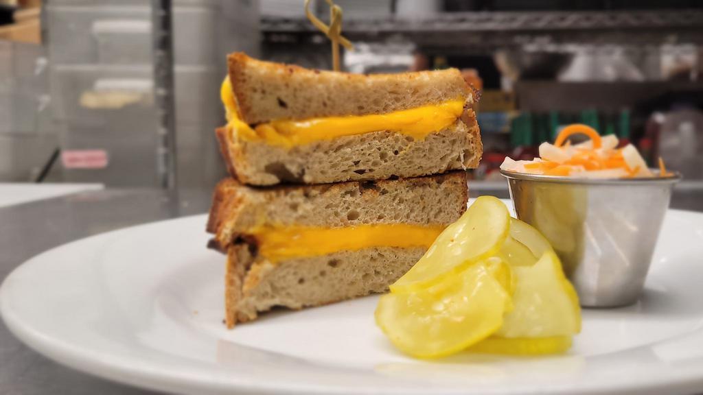Classic Grilled Cheese · American cheese on thick buttered toast.