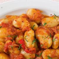 Gigantes · Greek giant white beans baked in a rich tomato dill sauce.