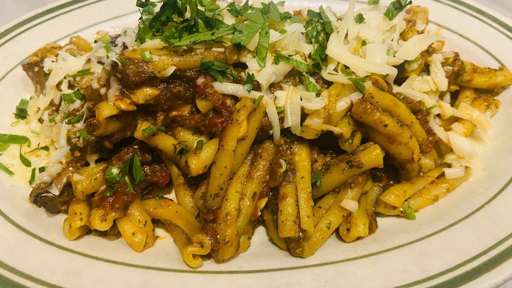 Casarecce Trapanese  · Short dry twisted pasta sauteed with roasted Sicilian eggplant, touch of plum tomato, basil almond pesto topped with sharp provolone cheese. (Traditional Sicilian dish from Trapani)