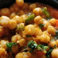 Chana Masala · Chickpeas cooked with chilies, onion, garlic, fresh cilantro, blend of spices, and tomatoes.