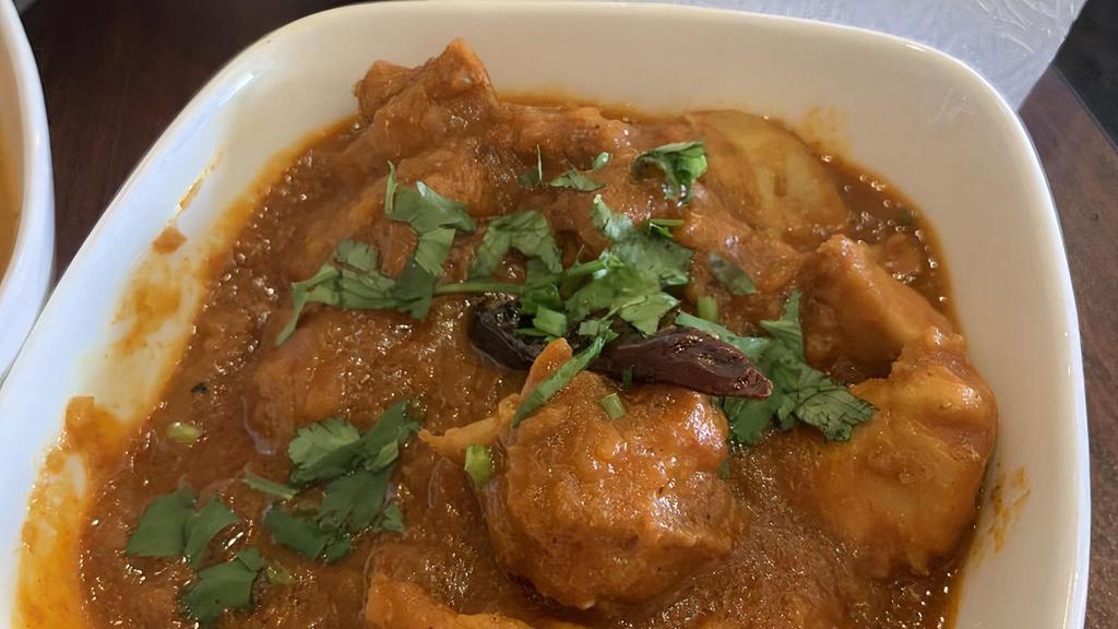 Chicken Vindaloo · Chicken cooked with potatoes and sun-dried kashmiri red-chili in a vindaloo sauce. Spicy. Mild.