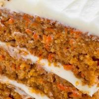 Carrot Cake · Triple layer carrot cake with real cream cheese, sliced walnuts and golden raisins.