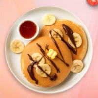 Banana Nutella Pancakes · Fluffy banana nutella pancakes cooked with care and love served with butter and maple syrup....