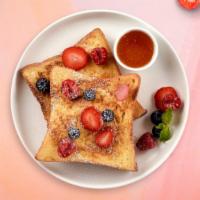 Berry French Toast · Fresh bread battered in egg, milk, and cinnamon cooked until spongy and golden brown. Topped...