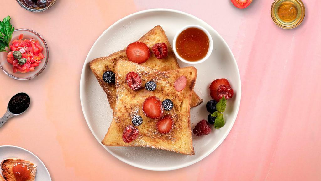 Berry French Toast · Fresh bread battered in egg, milk, and cinnamon cooked until spongy and golden brown. Topped with powdered sugar, berries, and served maple syrup.