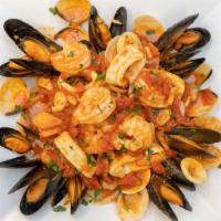Seafood Combination · Shrimp, mussels, calamari & clams over pasta