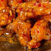 Alitas · Crispy chicken wings and chipotle sweet chili sauce.