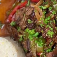 Lomo Saltado · Skirt steak strips sauteed with red onion, tomatoes, and cilantro. Served with rice and fries.