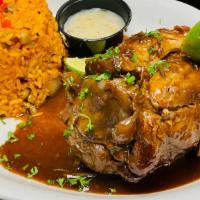 Lechon · Braised pork shank, pigeon pea rice, pickled onions, and garlic mojo.