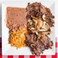 Carne Asada
 · Tender, grilled rib-eye steak served with fried beans, rice, lettuce, raw onions, tomatoes, ...