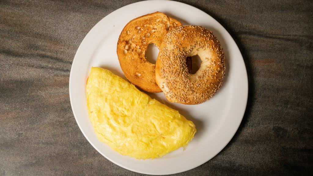 Cheese Omelet · Three-egg  omelet served with aged cheddar cheese & choice of bread