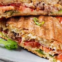 The Cajun Chicken Panini · Grilled cajun chicken, grilled veggies, and melted Swiss cheese. Served with chips and side ...