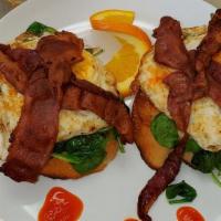 Cezanne'S Breakfast · Two over-light eggs in a bed of sauteed spinach topped with two slices of bacon over toasted...