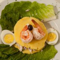 Causa Rellena De Camarones · Yellow whipped potatoes with onions and cilantro and shrimp.