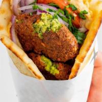 Falafel Pita · served with tomatoes, red onions and tzatziki all wrapped inside a toasted regular pita