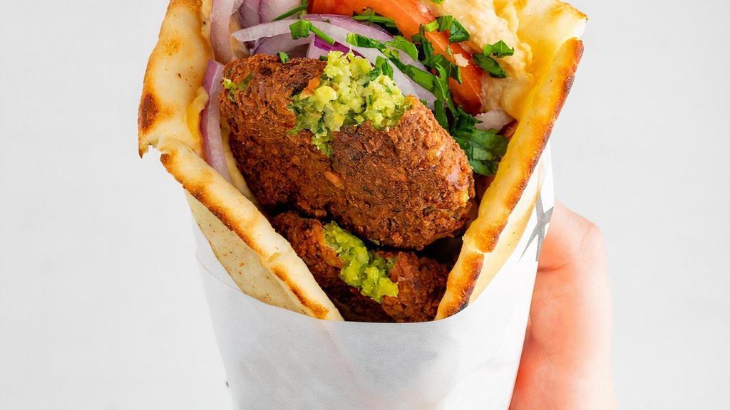 Falafel Pita · served with tomatoes, red onions and tzatziki all wrapped inside a toasted regular pita