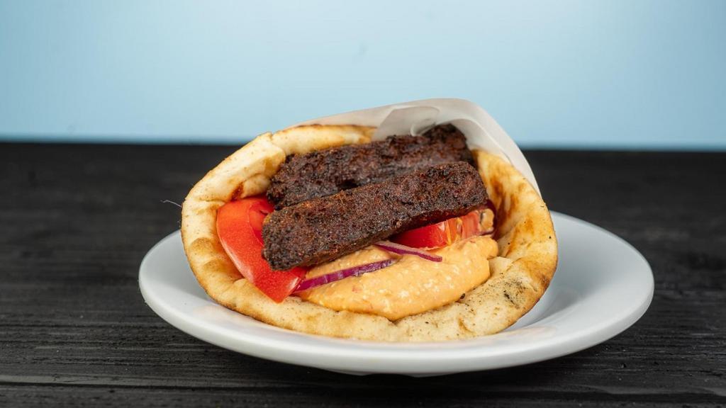 Zucchini Pita · served with tomatoes, red onions and tzatziki all wrapped inside a toasted regular pita