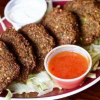 Falafel · Ground chickpeas, parsley, jalapeno peppers, and garlic. Falafel appetizer comes with salad ...