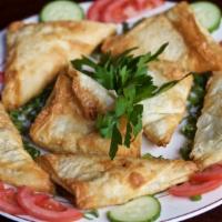 Spinach Pie (V) · Chopped fresh spinach, chopped onion, lemon juice and olive oil rolled in flaky fillo dough.