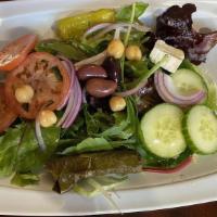 Mediterranean Salad · Romaine lettuce, tomatoes, cucumbers, red onions, Feta cheese, grape leaves and shredded car...
