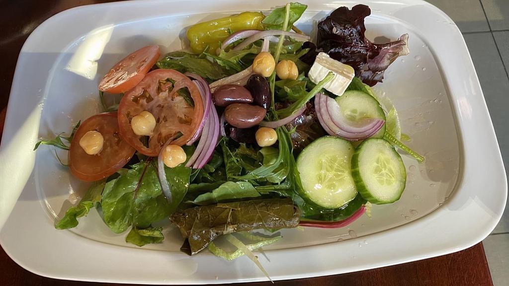 Mediterranean Salad · Romaine lettuce, tomatoes, cucumbers, red onions, Feta cheese, grape leaves and shredded carrots topped with olive oil and vinegar.