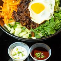 Bulgogi Bibimbap · Rice topped with Korean style marinated beef, mixed vegetables, and fried egg. Hot and sweet...
