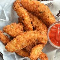 Chicken Tenders · Fresh batch of chicken fingers served with celery, carrots, and honey mustard.