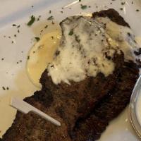Fraldinha Grelhada Com Molho De Manchego Cheese · Grilled Skirt steak topped with Manchego Cheese sauce, served with white rice and Spanish fr...