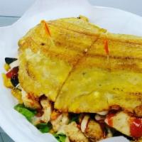Pollo Patacones · Chicken. A sandwich made with slices of twice fried green plantains instead of bread, with f...