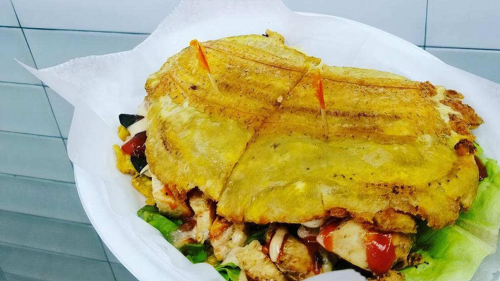 Pollo Patacones · Chicken. A sandwich made with slices of twice fried green plantains instead of bread, with fried cheese, the meat of your choice, lettuce, and tomatoes.