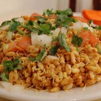 Bhelpuri (Gluten-Free, Vegan) · Mixture of puffed rice, sev, tomato, potato, onion, and sweet spicy chutneys.