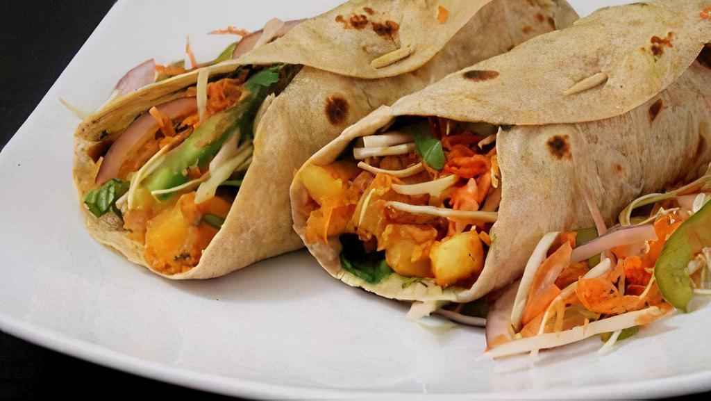 Vegetable Kati Roll ( 2 Pc) · Rolled parathas filled with cabbage, potatoes, carrots, onions and spices