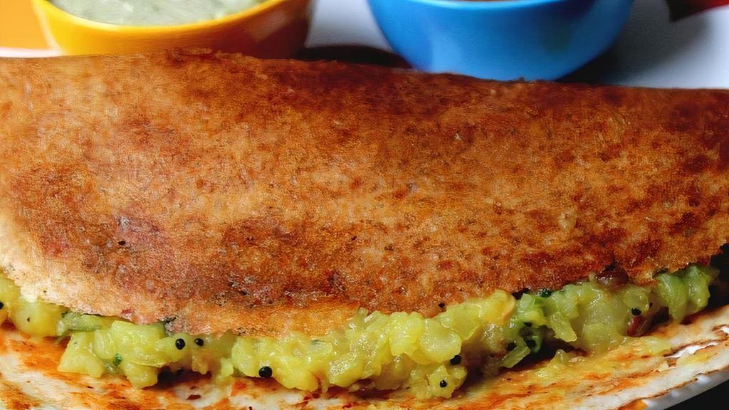 Mysore Masala Dosa (Gf, Vegan) · Hot Mysore spices added to the crispy rice and lentil crepe. Served plain or with mildly spiced potato masala. A dosa is a savory thin crepe made from a fermented batter of rice and black lentils. Dosas are naturally gluten free. Served with sambar and chutneys.