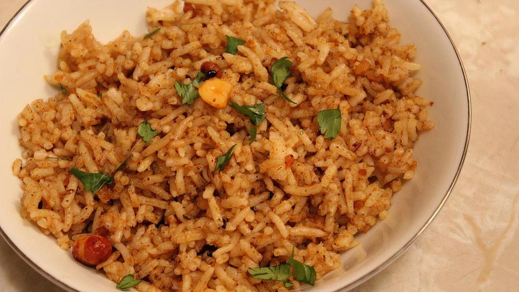Tamarind Rice (Has Peanuts) · Rice cooked in tamarind and spices. Served with sambar and papad.