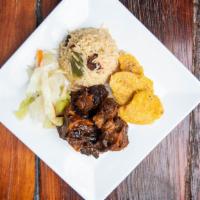 Bone In Oxtails · Rice and peas cabbage green plantains.