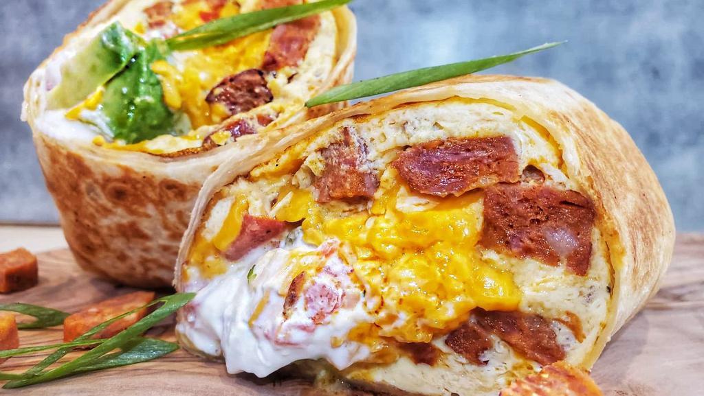 Breakfast Burrito · Scrambled eggs, chorizo, sour cream, pico de gallo, avocado, cheddar cheese, on wrap.