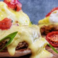 Crab Cakes Benedict · Poached eggs, English muffin, pico de gallo, hollandaise sauce, served with salad & skillet ...
